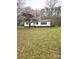 Charming home with a well-maintained lawn and beautiful, mature trees creating a welcoming entrance at 1607 W Nc 27 Hwy, Lincolnton, NC 28092
