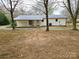 A full view of the home, including a covered porch, metal roof, and lovely surroundings at 1607 W Nc 27 Hwy, Lincolnton, NC 28092