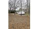 A view of the side and back of the house, surrounded by lush woodland at 1607 W Nc 27 Hwy, Lincolnton, NC 28092