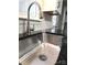 A clean, stainless steel kitchen sink with modern faucet, complemented by granite countertops and subway tile backsplash at 1607 W Nc 27 Hwy, Lincolnton, NC 28092