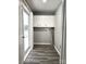 This laundry room features gray flooring, white walls, a window, and cabinetry at 1607 W Nc 27 Hwy, Lincolnton, NC 28092