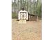 A view of the yard shed, with a ramp, barn doors, and a roof extension to the side at 1607 W Nc 27 Hwy, Lincolnton, NC 28092