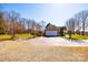 Spacious backyard featuring a detached garage with ample parking on a sunny day at 1636 Samaria Ln, Conover, NC 28613