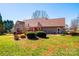Well-maintained backyard featuring a red deck and lush green lawn with mature landscaping at 1636 Samaria Ln, Conover, NC 28613