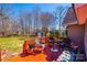 Relaxing outdoor deck area with red painted floor and wooded views at 1636 Samaria Ln, Conover, NC 28613