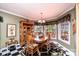 Bright dining room features a table with seating for four, a decorative rug and bay window views at 1636 Samaria Ln, Conover, NC 28613