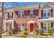 Charming brick townhouse with a red front door and manicured landscaping at 19009 Coachmans Trce, Cornelius, NC 28031