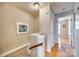 Upstairs hallway with hardwood floors and access to bedrooms at 19009 Coachmans Trce, Cornelius, NC 28031