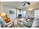 Comfortable living room with a ceiling fan, tile flooring, and ample seating at 19009 Coachmans Trce, Cornelius, NC 28031