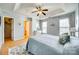 Light-filled main bedroom with tray ceiling, hardwood floors, and ensuite bathroom at 19009 Coachmans Trce, Cornelius, NC 28031