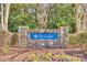 Glenridge community entrance sign with stone pillars, flowerbeds, and lush greenery at 19009 Coachmans Trce, Cornelius, NC 28031