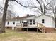 View of the back of house with a deck and a beautiful lawn, perfect for outdoor enjoyment at 211 W 1St St, Landis, NC 28088