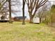 Expansive backyard features a large shed, complemented by established trees and lush green grass at 211 W 1St St, Landis, NC 28088