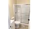 Bathroom featuring a clean shower with a sliding glass door and neutral tiling at 211 W 1St St, Landis, NC 28088