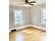 This bedroom features hardwood floors, neutral walls, and two windows at 211 W 1St St, Landis, NC 28088
