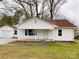 Charming single-story home with a cozy front porch, complemented by well-manicured front lawn at 211 W 1St St, Landis, NC 28088