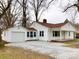 Charming single-story home with white siding and a detached garage in a well-maintained yard at 211 W 1St St, Landis, NC 28088