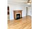 Bright living room with hardwood floors and a charming fireplace at 211 W 1St St, Landis, NC 28088