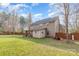 Expansive fenced backyard with mature trees and a covered porch, great for entertaining and enjoying nature at 2157 Tommy Ln, Matthews, NC 28105