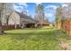 Large backyard featuring a covered patio, wooden fence, and mature trees, perfect for outdoor gatherings at 2157 Tommy Ln, Matthews, NC 28105