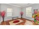 Bright bedroom with hardwood floors, large windows, and a decorative area rug, offering ample natural light at 2157 Tommy Ln, Matthews, NC 28105