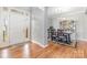 Bright entryway with hardwood floors leading to a dining area, showcasing a decorative cabinet at 2157 Tommy Ln, Matthews, NC 28105