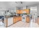 Well-lit kitchen with light wood cabinets, white appliances, and granite countertops, open to the living area at 2157 Tommy Ln, Matthews, NC 28105