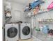 Functional laundry room with a washer, dryer, and ample shelving for storage, offering convenience and organization at 2157 Tommy Ln, Matthews, NC 28105
