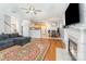 Open-concept living room flowing into the kitchen and breakfast area, with hardwood floors and a fireplace at 2157 Tommy Ln, Matthews, NC 28105