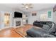 Inviting living room features a fireplace, hardwood floors, and a comfortable gray sectional sofa at 2157 Tommy Ln, Matthews, NC 28105