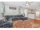 Spacious living room featuring hardwood floors, a gray sectional sofa, and an open layout to the kitchen at 2157 Tommy Ln, Matthews, NC 28105