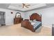 Large main bedroom with a tray ceiling, carpeted floors, and elegant dark wood furniture at 2157 Tommy Ln, Matthews, NC 28105