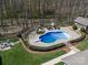 Aerial view of a backyard featuring an in-ground pool, fire pit and a detached garage at 3024 Beaver Dam Dr, Monroe, NC 28110