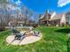 Large backyard featuring a fire pit and a partial view of the in-ground pool at 3024 Beaver Dam Dr, Monroe, NC 28110