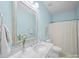 A bright bathroom with blue walls, marble countertops, and a neutral shower curtain at 3024 Beaver Dam Dr, Monroe, NC 28110