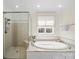 Bright bathroom with a separate shower, jetted tub, and white cabinets at 3024 Beaver Dam Dr, Monroe, NC 28110