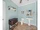 Light and airy bathroom with light blue walls, a pedestal sink, and wood-look tile flooring at 3024 Beaver Dam Dr, Monroe, NC 28110