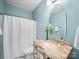 Powder room features an decorative mirror, marble counter and blue walls at 3024 Beaver Dam Dr, Monroe, NC 28110