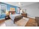 A bedroom with gray and blue walls, hardwood floors, and deer decorations at 3024 Beaver Dam Dr, Monroe, NC 28110