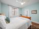 A bedroom with light blue walls, a ceiling fan, and hardwood floors at 3024 Beaver Dam Dr, Monroe, NC 28110