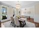 Elegant dining room with wainscoting, chandelier, and large windows providing ample natural light at 3024 Beaver Dam Dr, Monroe, NC 28110