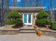 Charming brick entrance featuring double doors, manicured shrubs, and stone steps leading to the home at 3024 Beaver Dam Dr, Monroe, NC 28110