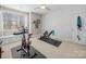 Exercise room featuring stationary bike and weight bench by window at 3024 Beaver Dam Dr, Monroe, NC 28110
