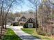 Beautiful brick and stone home on a large lot featuring a long driveway and well manicured lawn at 3024 Beaver Dam Dr, Monroe, NC 28110