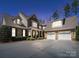Beautiful brick and stone home featuring a spacious driveway, front porch and a three car garage at 3024 Beaver Dam Dr, Monroe, NC 28110