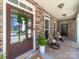 Inviting front porch with stone accents, comfortable seating, and a welcoming entrance with seasonal wreath at 3024 Beaver Dam Dr, Monroe, NC 28110
