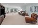 Spacious game room offering a ping pong table, multiple seating areas and neutral carpet at 3024 Beaver Dam Dr, Monroe, NC 28110