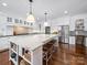 Gourmet kitchen with a large island, white cabinets, stainless steel appliances, and hardwood floors at 3024 Beaver Dam Dr, Monroe, NC 28110