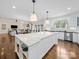 Bright kitchen featuring a large island with marble countertops and pendant lighting at 3024 Beaver Dam Dr, Monroe, NC 28110