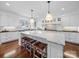 Spacious white kitchen featuring a large island, marble countertops and wooden stools at 3024 Beaver Dam Dr, Monroe, NC 28110